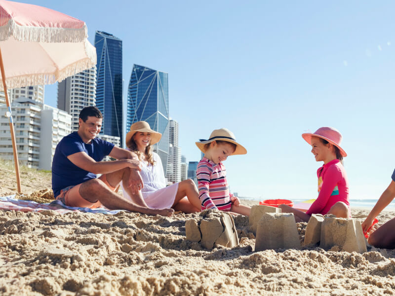 A family with three children playing on the beach in Broadbeach.