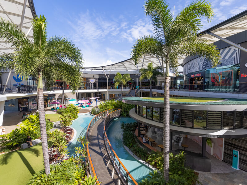 Image of the central Pacific Fair Shopping centrewith shops in teh background and palm trees