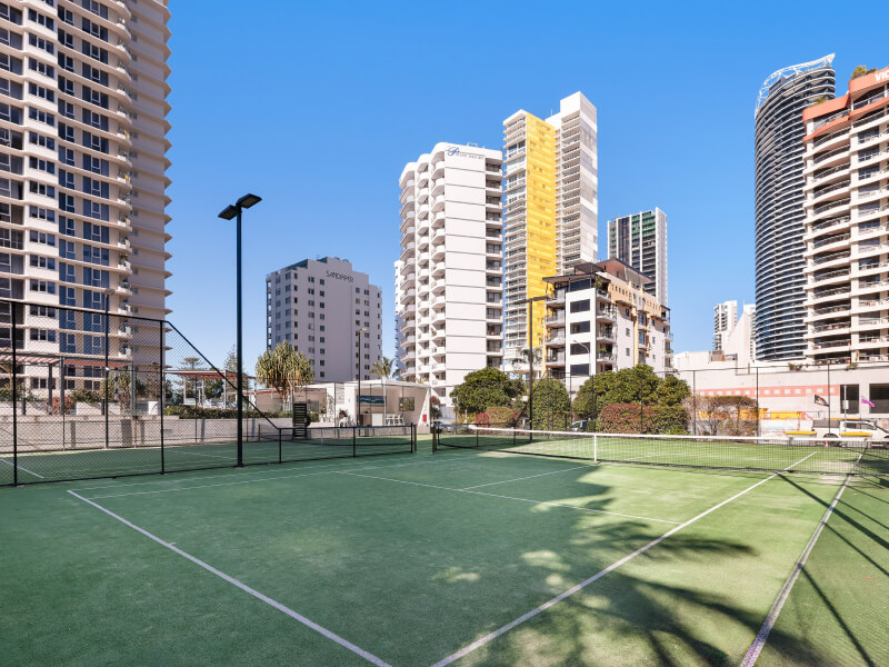 Resort pool area at ULTIQA Points North with sun loungers, palm trees, and a large swimming pool under a clear blue sky.