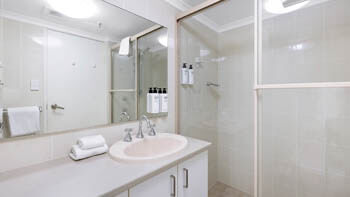 Twin bedroom with city skyline views and natural light at ULTIQA Beach Haven on Broadbeach.