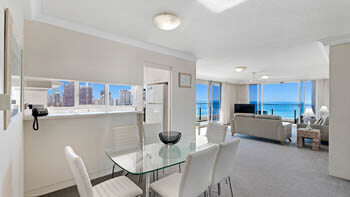 Open plan living and dining area with ocean outlook at ULTIQA Beach Haven on Broadbeach.