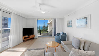 Modern living room with ocean views and private balcony at ULTIQA Beach Haven on Broadbeach.