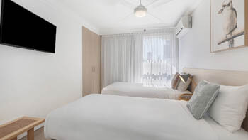 Twin bedroom with coastal décor at ULTIQA Beach Haven on Broadbeach.
