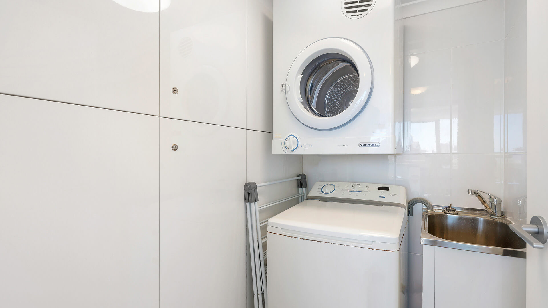 In-apartment laundry with washer, dryer and sink at ULTIQA Beach Haven on Broadbeach, Surfers Paradise.