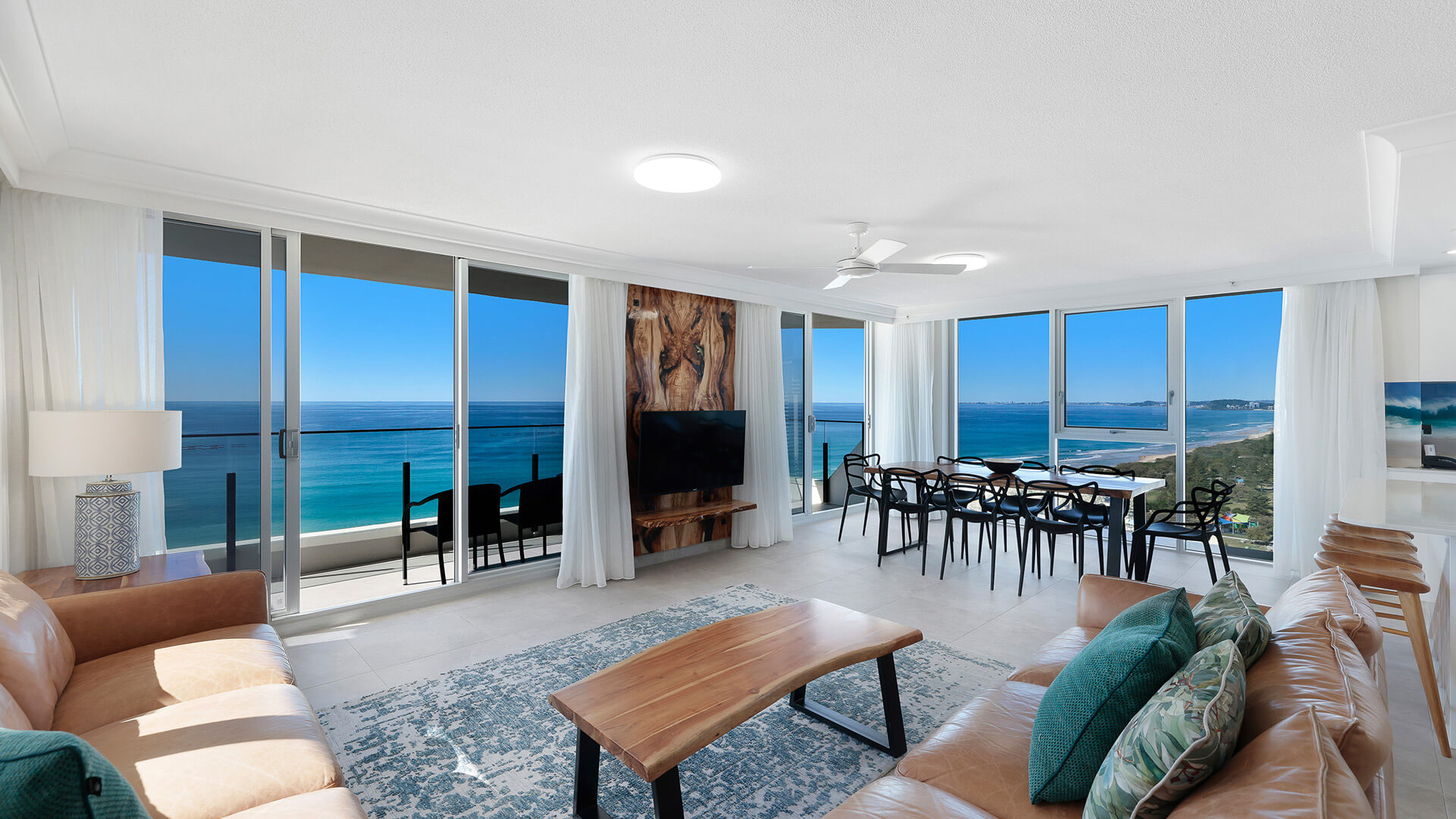 Open-plan lounge and dining with wraparound ocean outlook at ULTIQA Beach Haven on Broadbeach, Gold Coast.