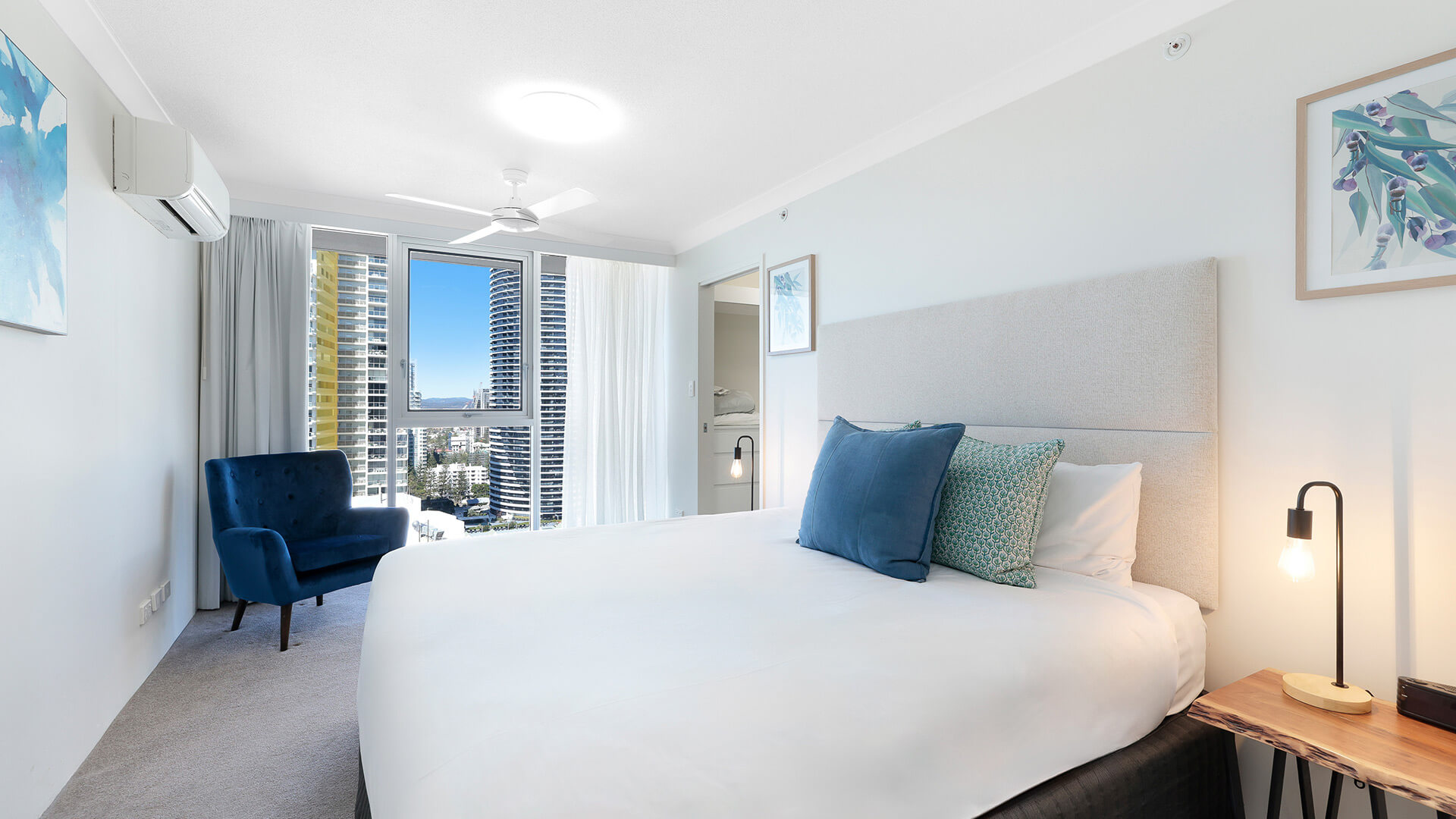 Main bedroom with plush bedding and city views at ULTIQA Beach Haven on Broadbeach, Surfers Paradise apartment.