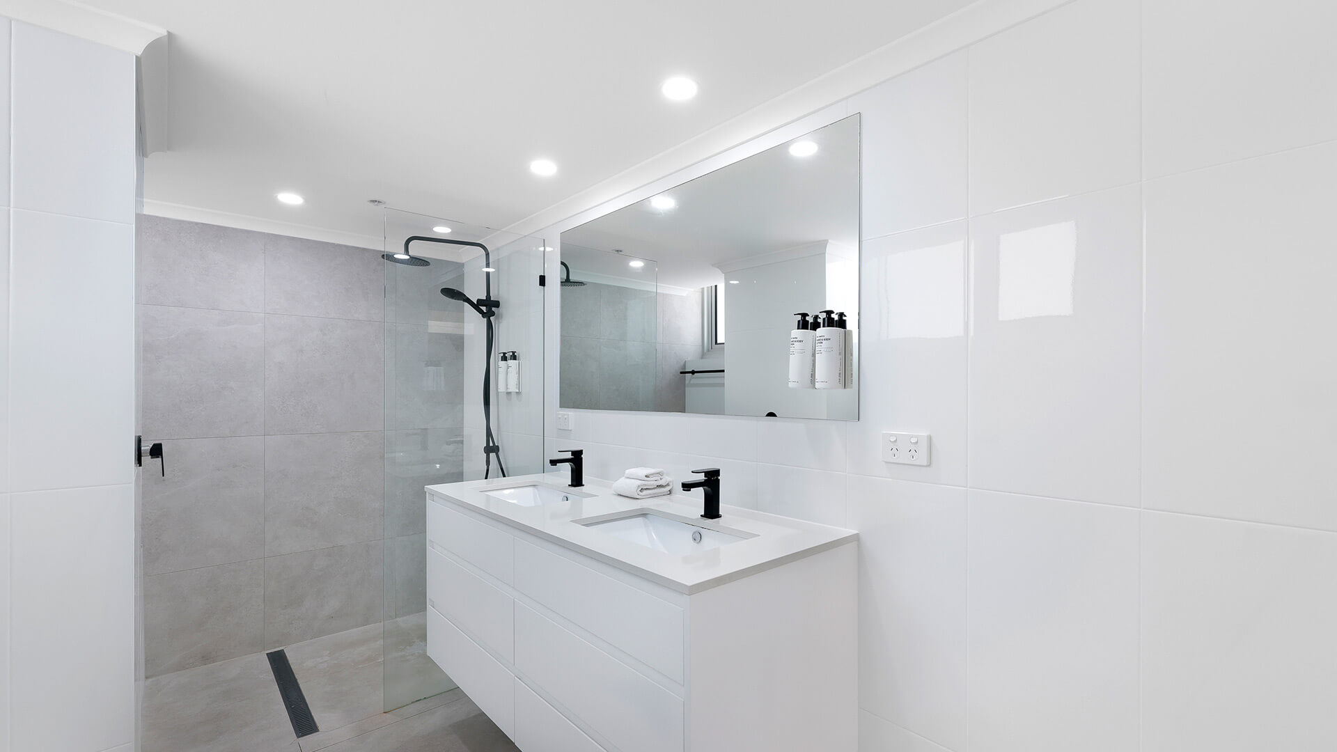 Modern bathroom with double vanity and walk-in shower at ULTIQA Beach Haven on Broadbeach, Surfers Paradise apartment.