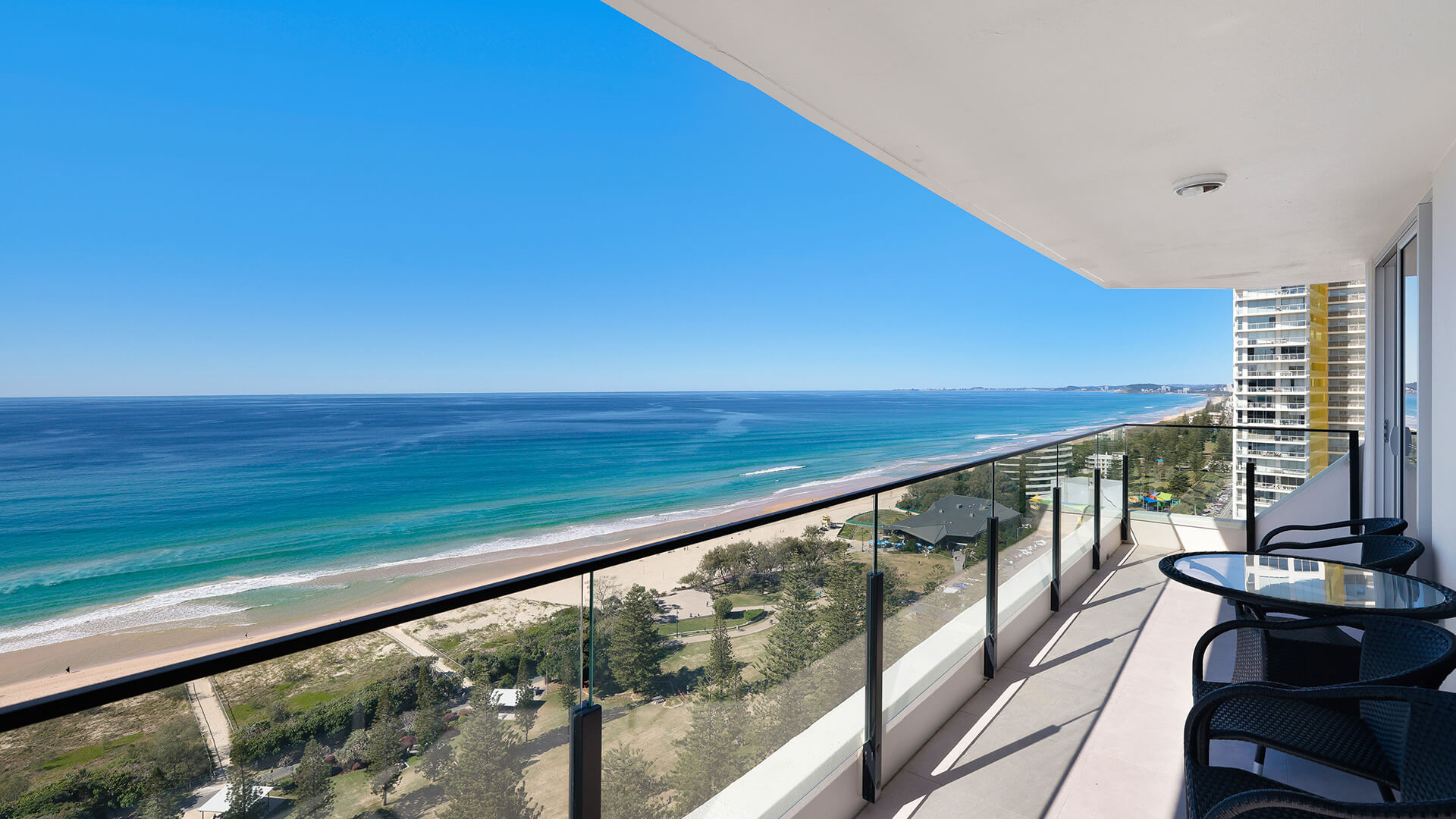 Oceanfront balcony with seating and sweeping coastline views at ULTIQA Beach Haven on Broadbeach, Surfers Paradise.