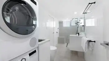 Spacious bathroom with washer and dryer plus walk-in shower at ULTIQA Beach Haven on Broadbeach, Gold Coast accommodation.