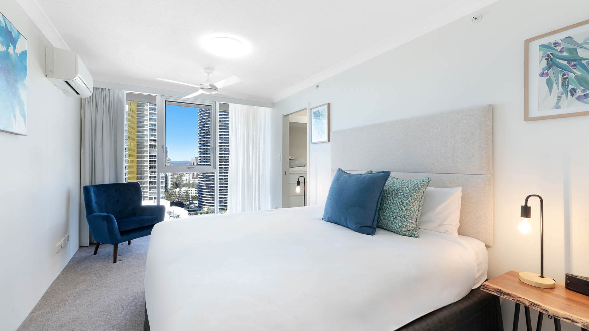 Master bedroom with city views and king bed.
